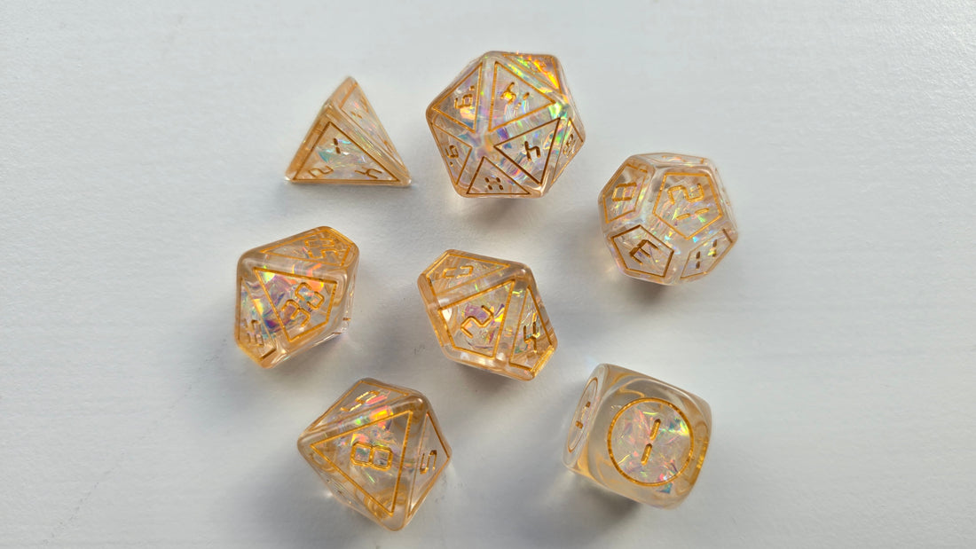 A set of transparent, holographic polyhedral dice resting on a white surface in bright natural sunlight.