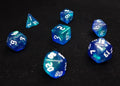Meteor Storm Polyhedral Dice Set - Green and Blue Translucent Swirl Dice with Reflect Micro Glitter and White Numbers